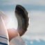 Jewish man blowing the Shofar against blue sky